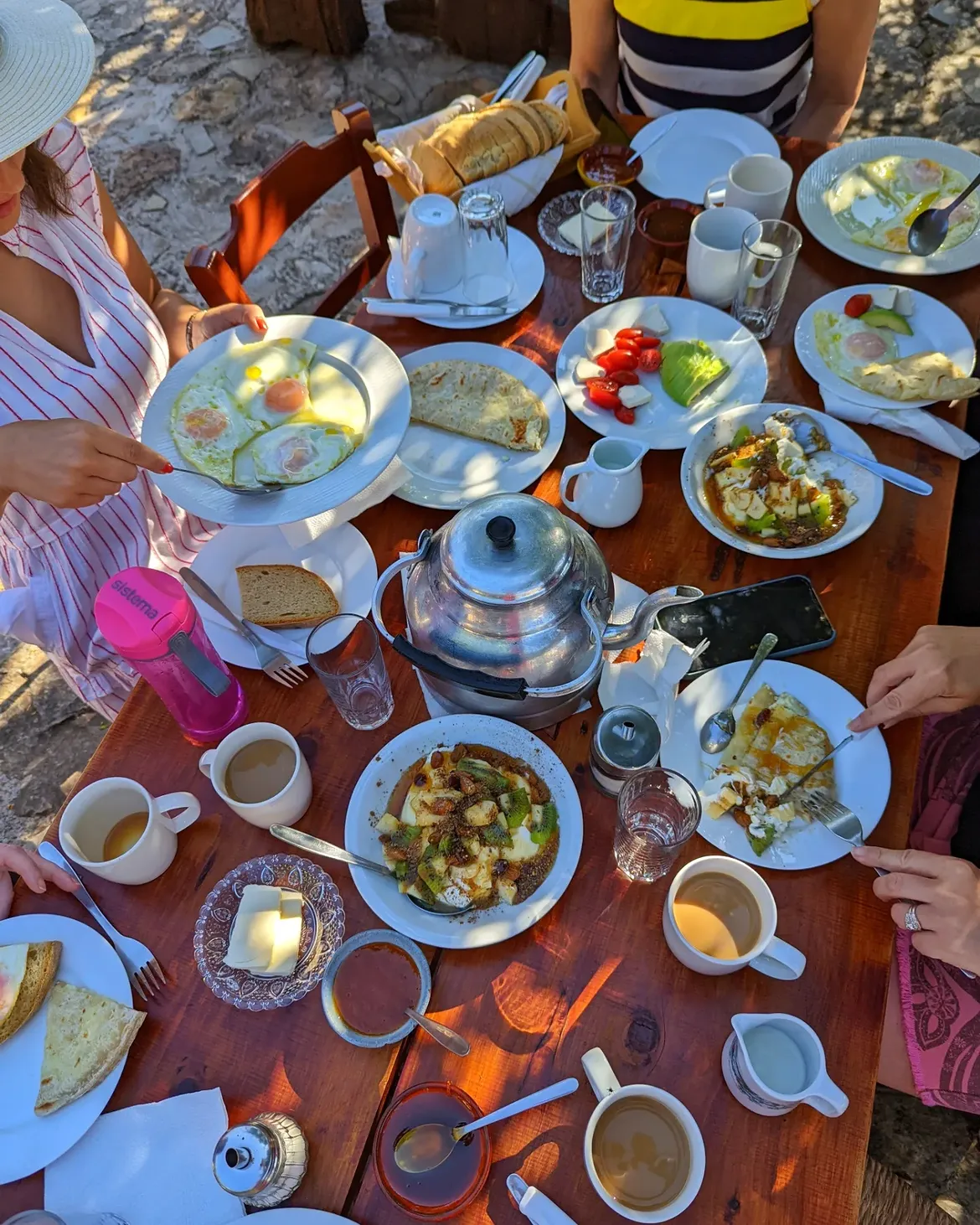 Breakfast spread at Alonia with fresh eggs, cheeses, tomatoes, honey and mountain tea served outdoors