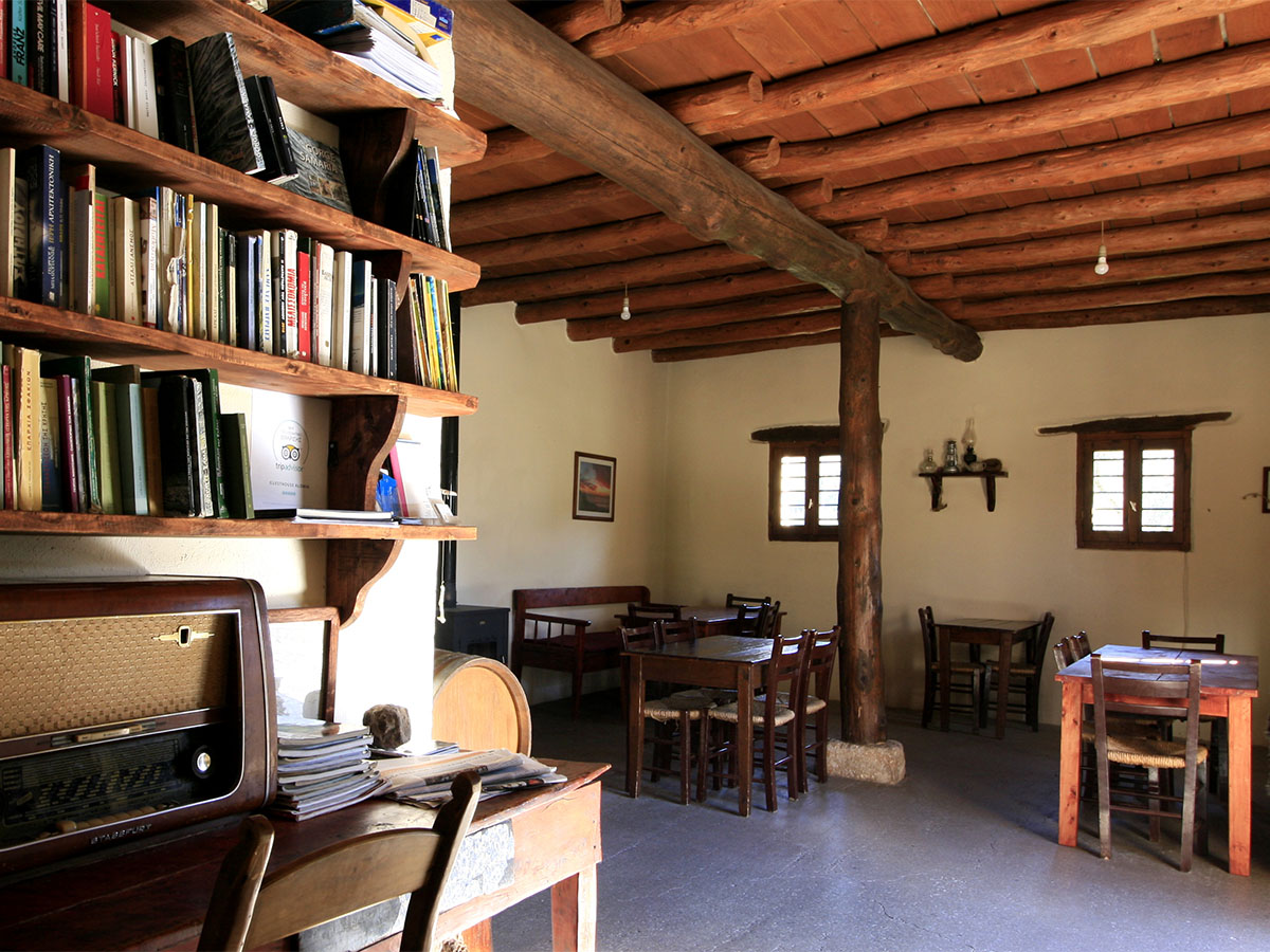 The old common room at Alonia, now a small restaurant with wood beam ceiling and reading shelves