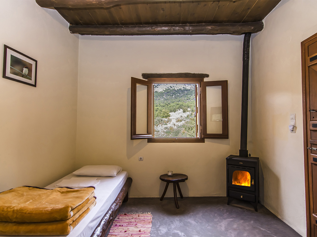 Single room with wood stove and forest view